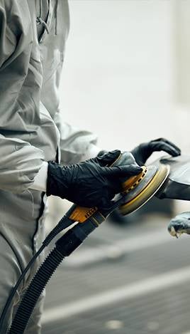 Sanding car body panel with orbital sander